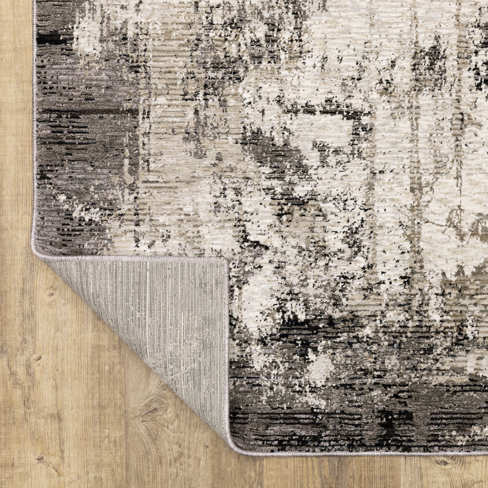 Vintage distressed grey and cream rug with abstract mottled texture pattern