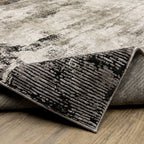 Vintage distressed grey and cream rug with abstract mottled texture pattern