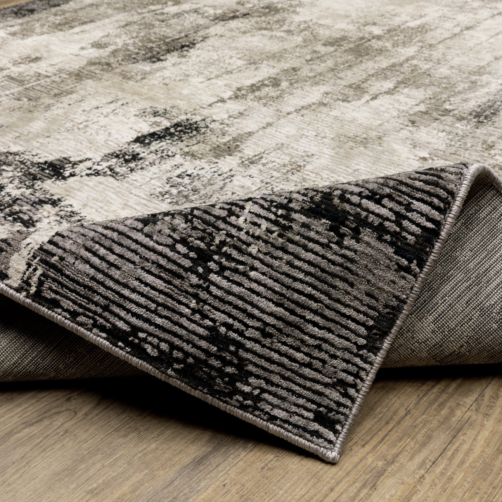Vintage distressed grey and cream rug with abstract mottled texture pattern