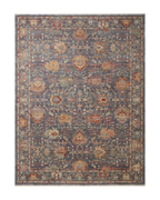 Vintage-style area rug with ornate floral medallions in blue, rust, and gold tones