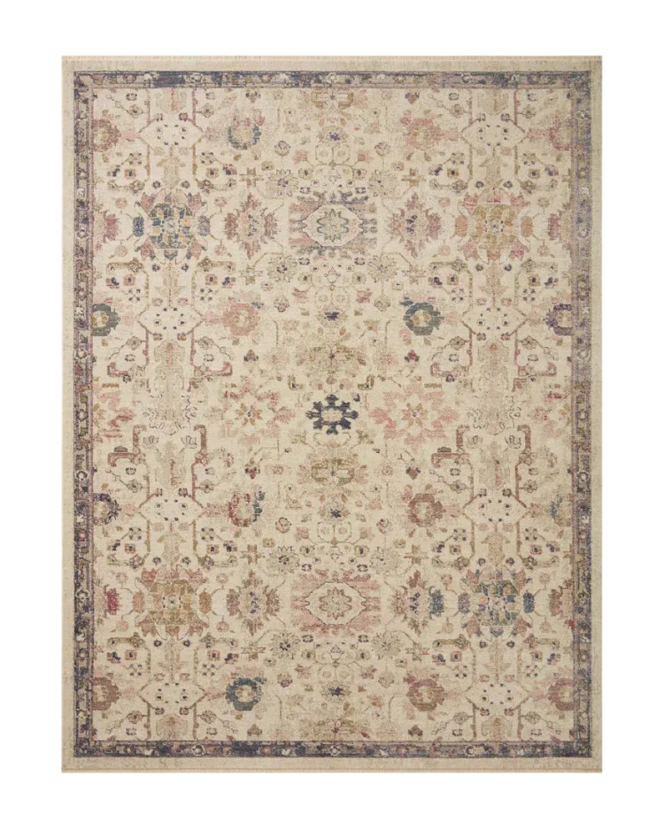 Vintage-style area rug with cream base, intricate geometric and floral patterns in rust and blue tones