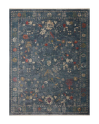 Blue vintage-style rug with floral motifs and ornate border design
