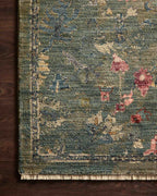 Vintage-style rug with blue-gray base and faded floral pattern in cream and red tones