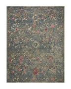 Vintage-style rug with blue-gray base and faded floral pattern in cream and red tones