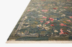 Vintage-style rug with blue-gray base and faded floral pattern in cream and red tones