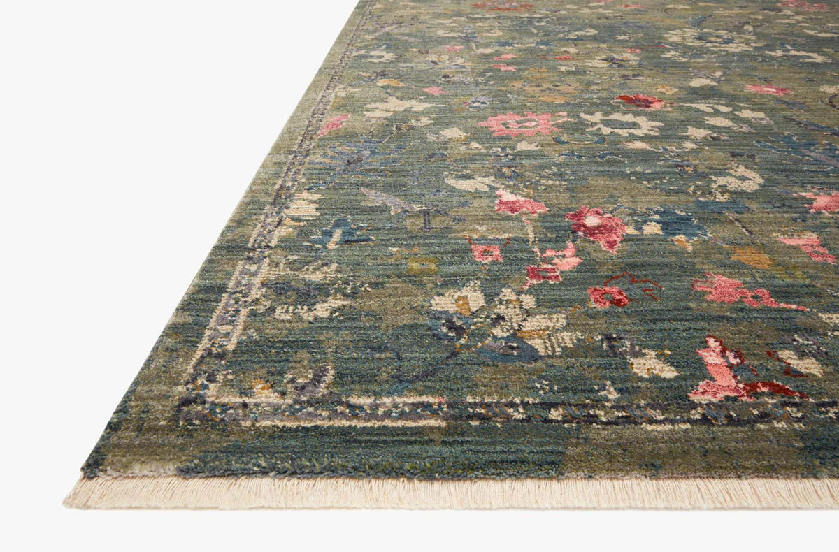 Vintage-style rug with blue-gray base and faded floral pattern in cream and red tones