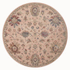 Blush pink traditional rug with intricate floral motifs and ornate border design