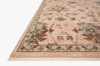 Blush pink traditional rug with intricate floral motifs and ornate border design