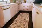 Blush pink traditional rug with intricate floral motifs and ornate border design