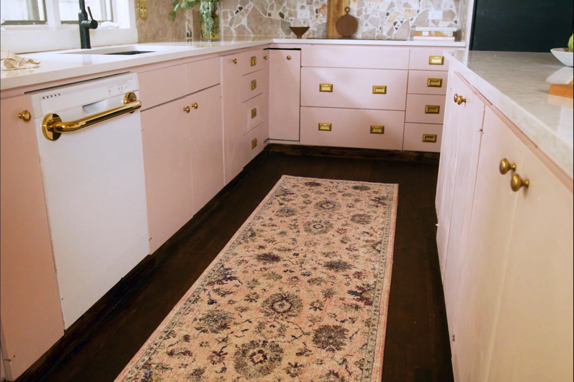Blush pink traditional rug with intricate floral motifs and ornate border design