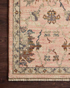 Blush pink traditional rug with intricate floral motifs and ornate border design