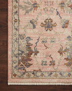 Blush pink traditional rug with intricate floral motifs and ornate border design