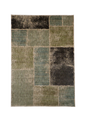 Modern geometric patchwork rug in green, black, and neutral tones with textured weave
