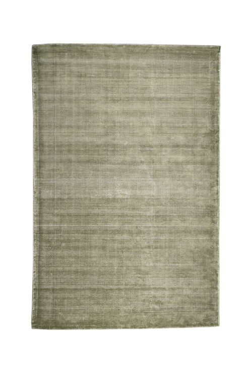 Sage green textured velvet rug with subtle worn vintage distressing throughout