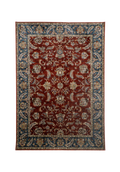 Red traditional rug with ornate floral patterns and blue border design
