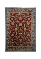 Red traditional rug with ornate floral patterns and blue border design