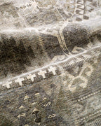Vintage patchwork rug with geometric patterns in gray and cream tones