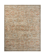 Vintage-style area rug with distressed beige and tan damask pattern throughout