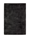 Black wool rug with white polka dot pattern and textured pile surface