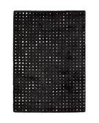 Black wool rug with white polka dot pattern and textured pile surface