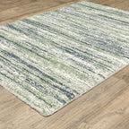 Striped area rug with green, navy and cream horizontal bands in textured weave
