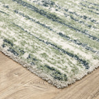Striped area rug with green, navy and cream horizontal bands in textured weave