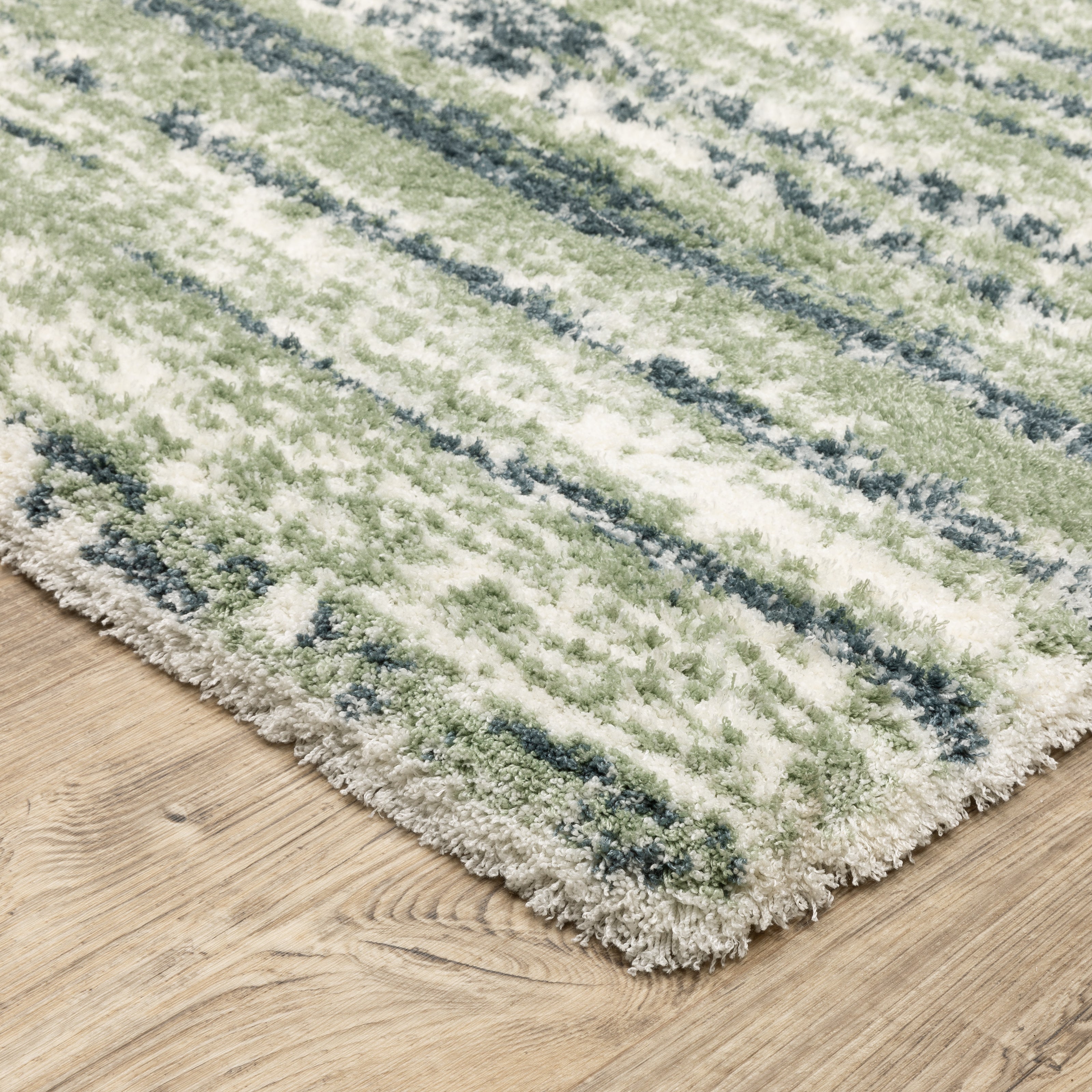 Striped area rug with green, navy and cream horizontal bands in textured weave
