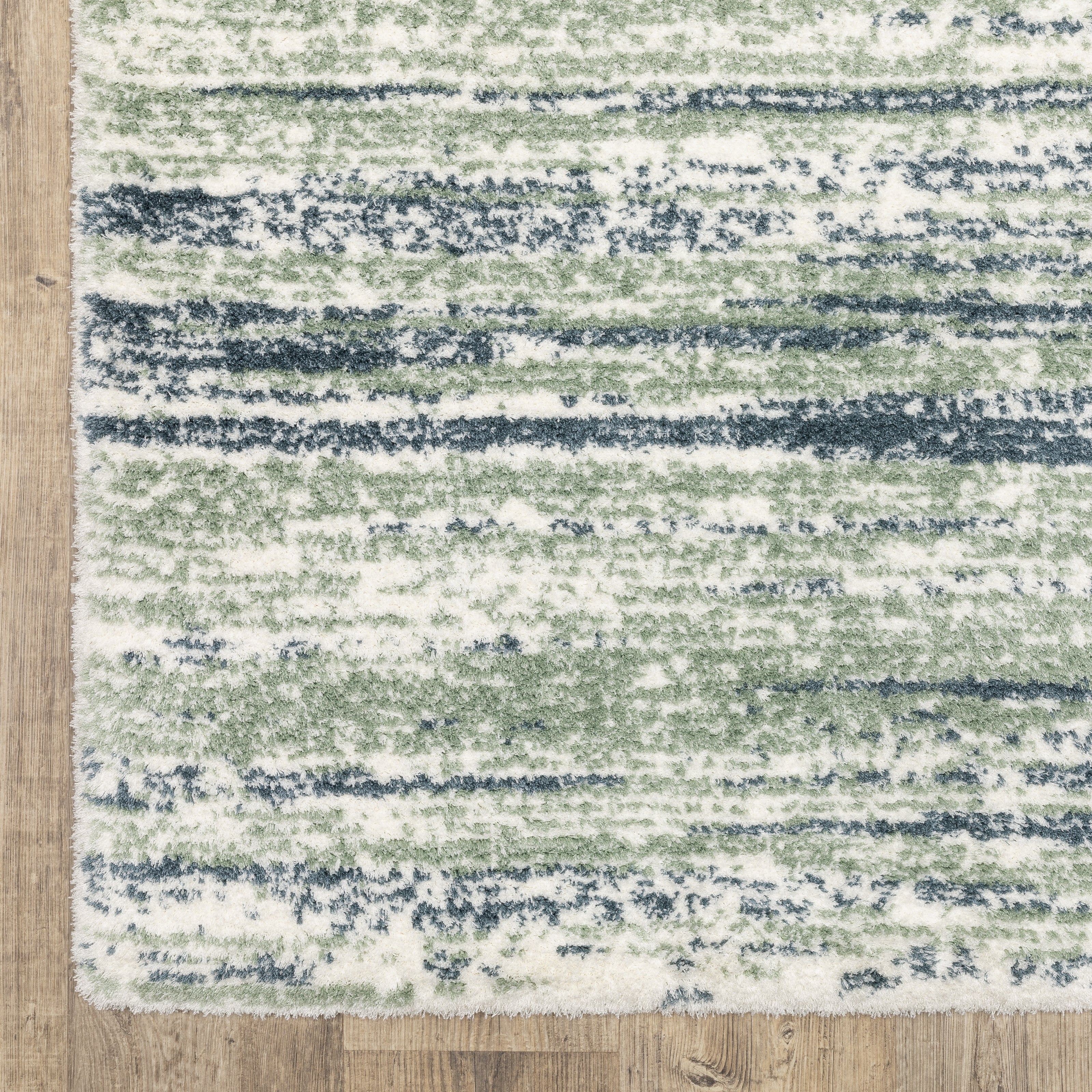 Striped area rug with green, navy and cream horizontal bands in textured weave