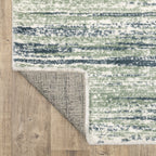 Striped area rug with green, navy and cream horizontal bands in textured weave