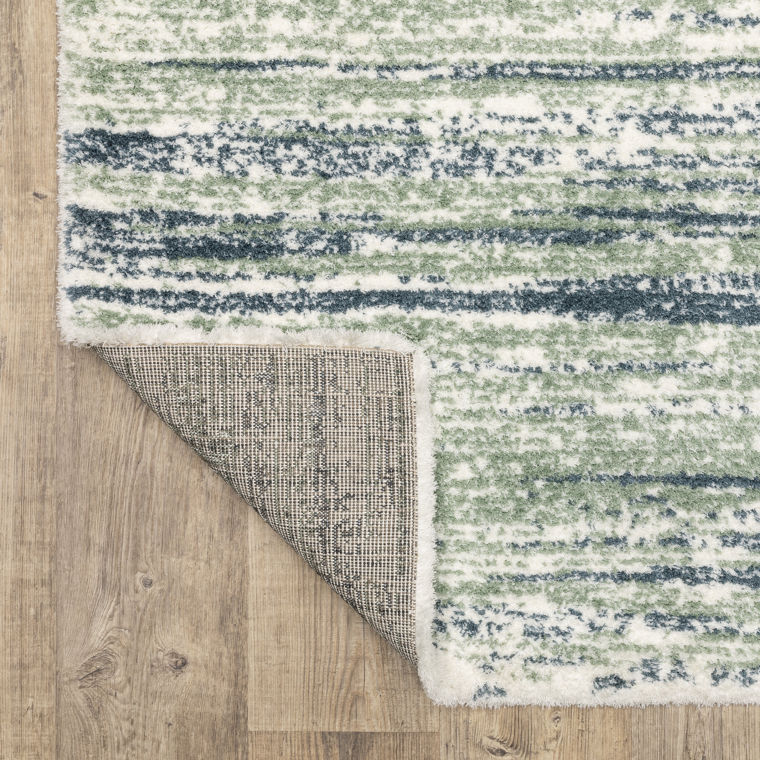 Striped area rug with green, navy and cream horizontal bands in textured weave