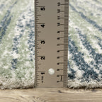 Striped area rug with green, navy and cream horizontal bands in textured weave