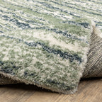 Striped area rug with green, navy and cream horizontal bands in textured weave