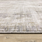 Modern distressed grey and cream textured rug with abstract worn pattern