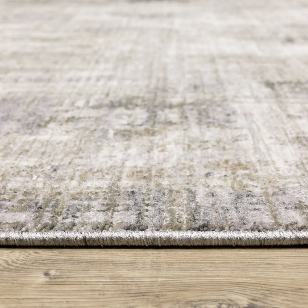 Modern distressed grey and cream textured rug with abstract worn pattern