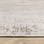Distressed beige and grey textured rug with mottled vintage appearance