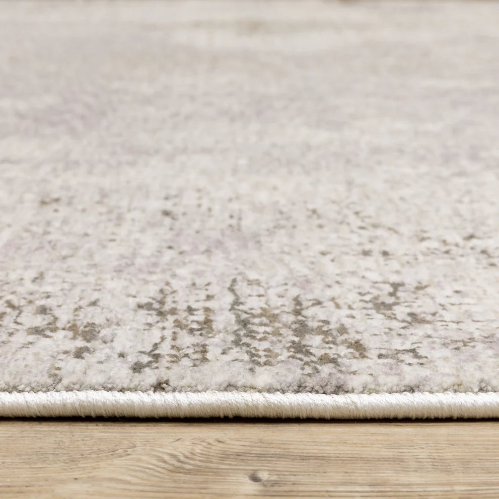 Distressed beige and grey textured rug with mottled vintage appearance