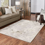 Distressed beige and grey textured rug with mottled vintage appearance