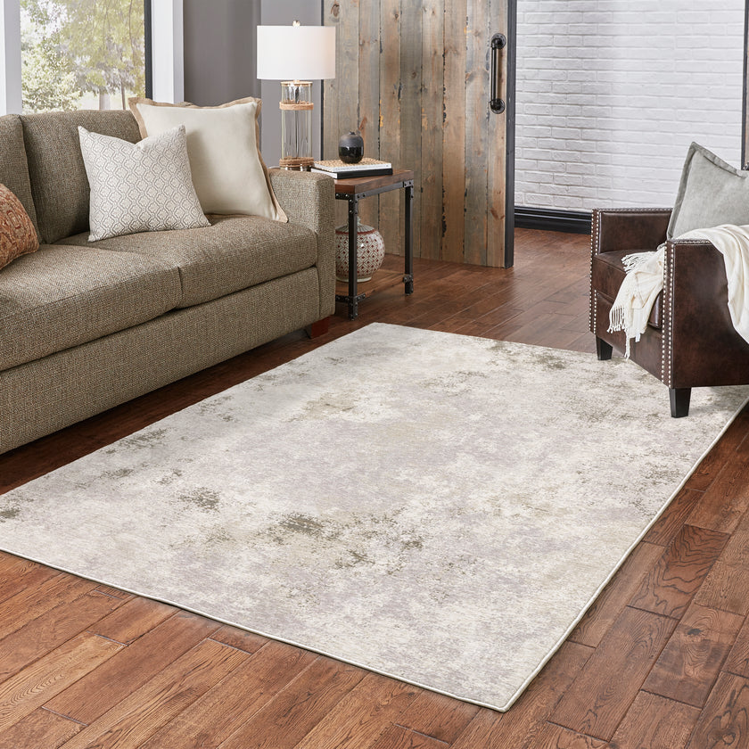 Distressed beige and grey textured rug with mottled vintage appearance