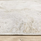 Beige and taupe marbled swirl pattern area rug with textured finish