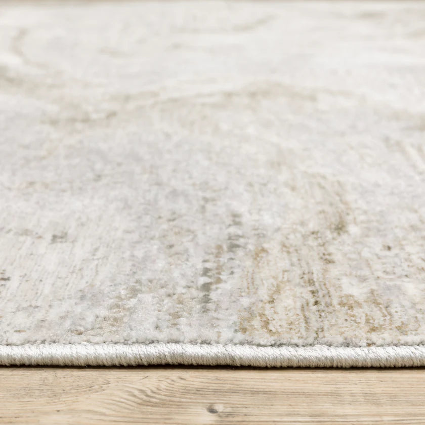 Beige and taupe marbled swirl pattern area rug with textured finish