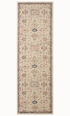Vintage-style area rug with cream base, intricate geometric and floral patterns in rust and blue tones