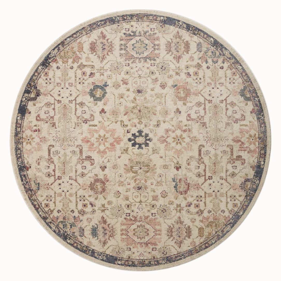 Vintage-style area rug with cream base, intricate geometric and floral patterns in rust and blue tones
