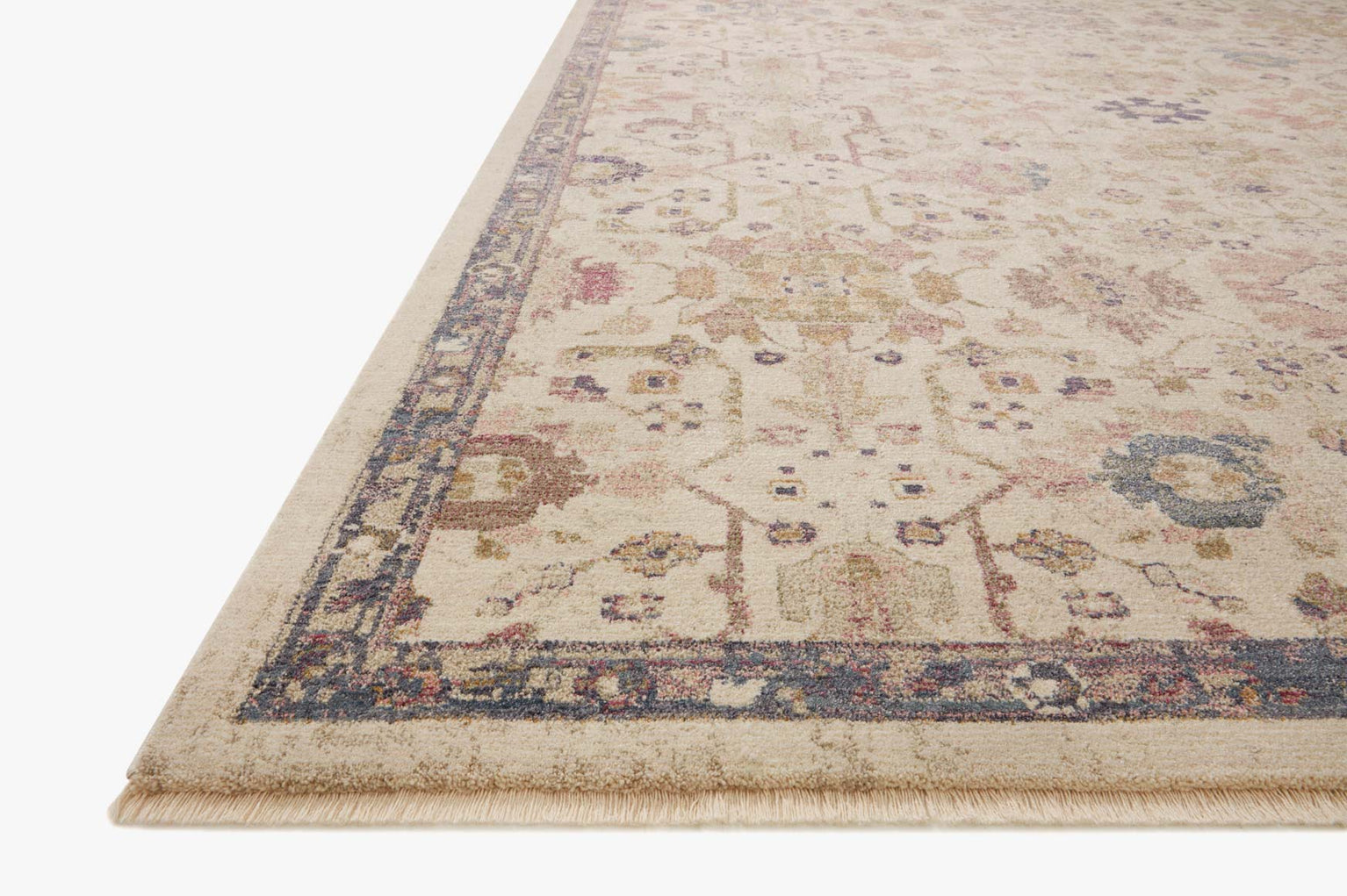 Vintage-style area rug with cream base, intricate geometric and floral patterns in rust and blue tones