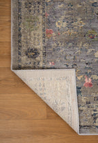 Gray traditional rug with pink floral motifs and ornate border design