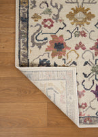 Cream wool rug with multicolored floral medallions and ornate border design