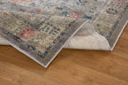 Gray traditional rug with pink floral motifs and ornate border design