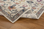 Cream wool rug with multicolored floral medallions and ornate border design